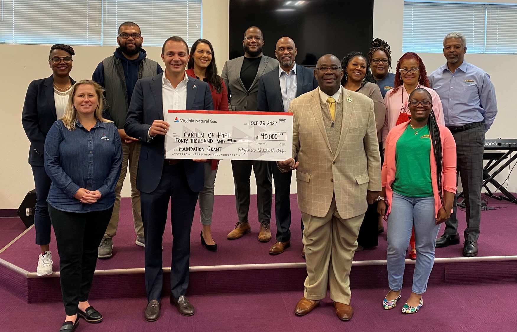 a group of people holding a large check